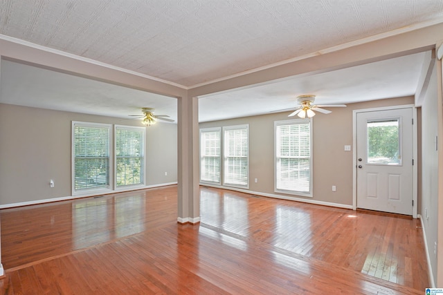2928 University Way, Centreville, AL 35042 - unfurnished living room with crown molding, a ceiling fan, and wood-type flooring