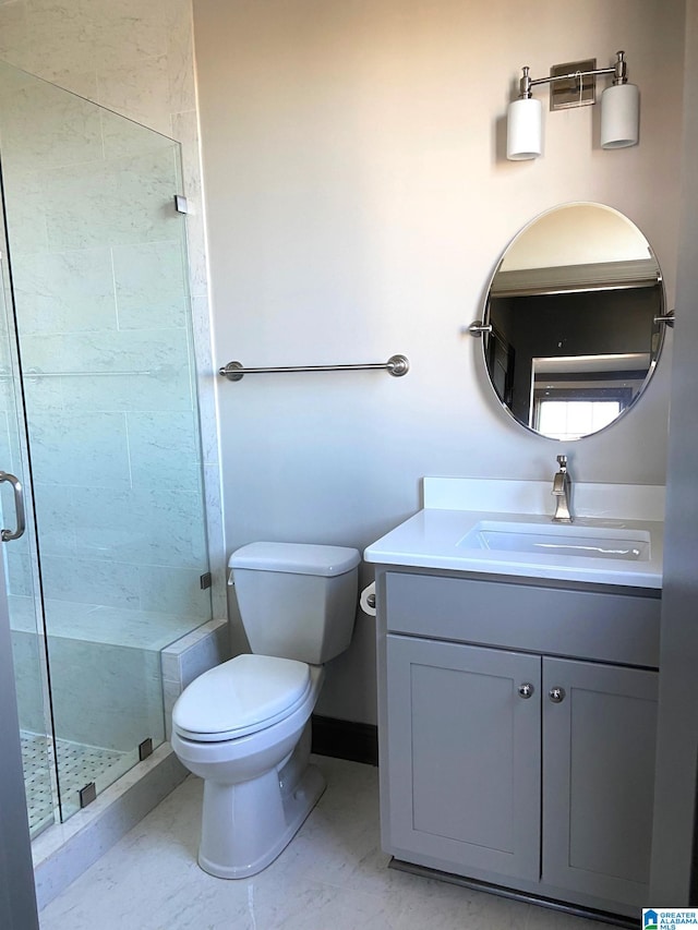 full bath featuring vanity, baseboards, a shower stall, and toilet