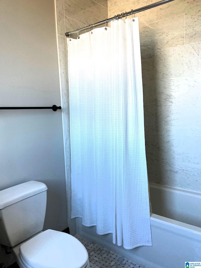 full bath featuring shower / tub combo and toilet
