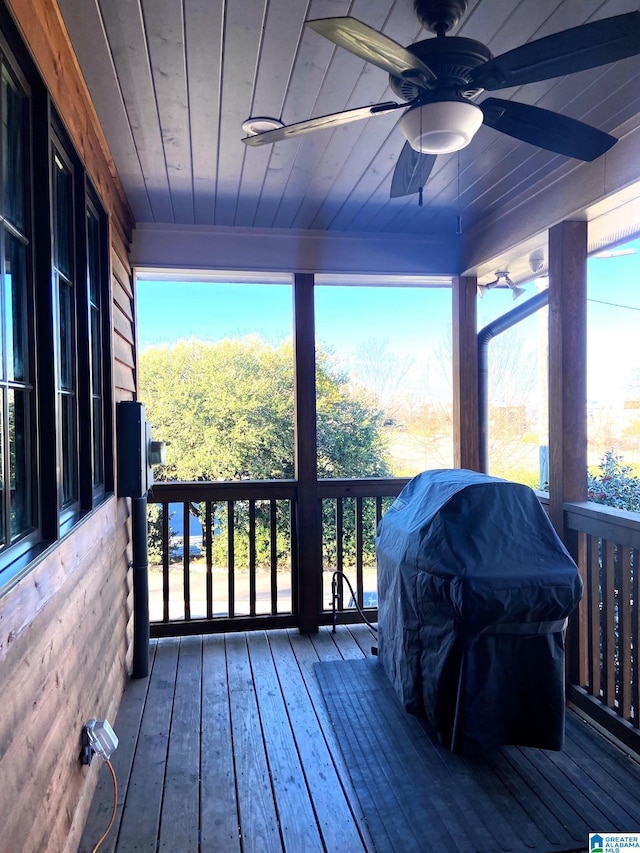 wooden terrace with grilling area and ceiling fan