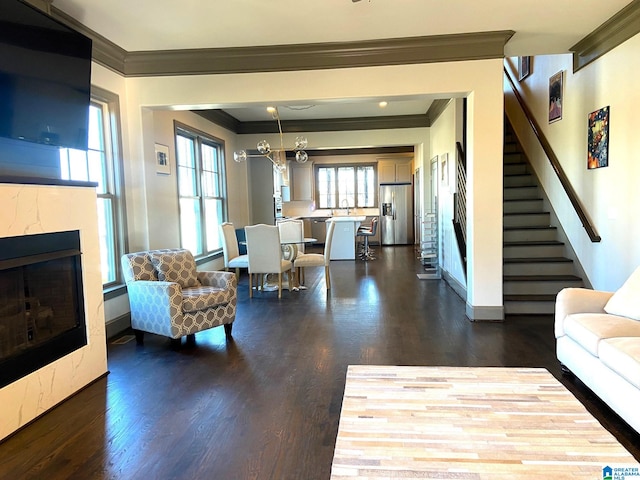 living area with ornamental molding, stairs, a fireplace, baseboards, and dark wood-style floors