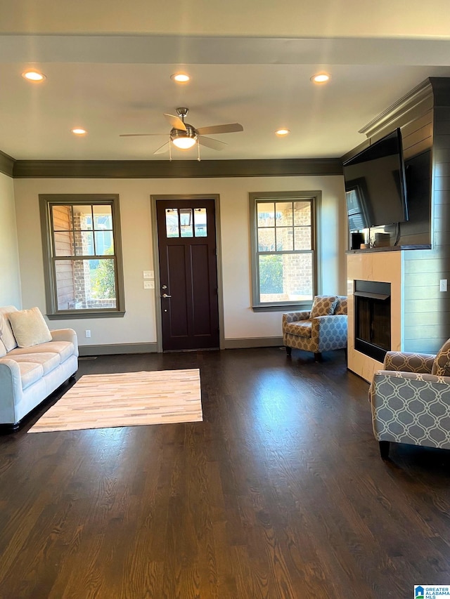 foyer entrance featuring baseboards, plenty of natural light, ornamental molding, and a fireplace