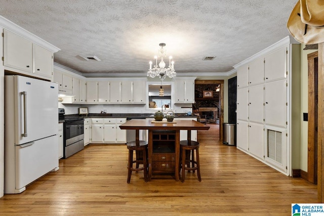 dining area featuring visible vents, light wood-style flooring, and a notable chandelier