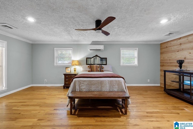 bedroom with ornamental molding, light wood-style flooring, and multiple windows