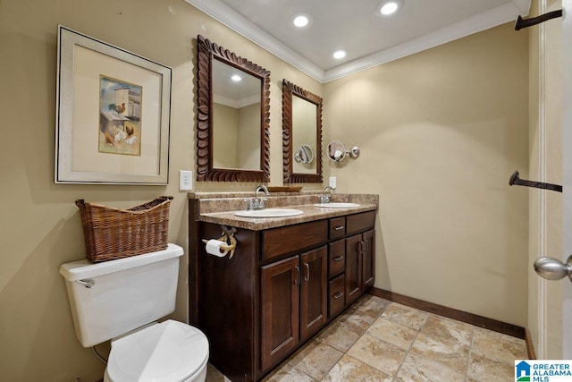 bathroom featuring toilet, baseboards, ornamental molding, and a sink
