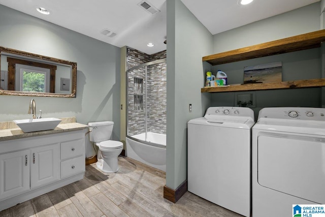 full bath with visible vents, washer and clothes dryer, wood finished floors, and vanity