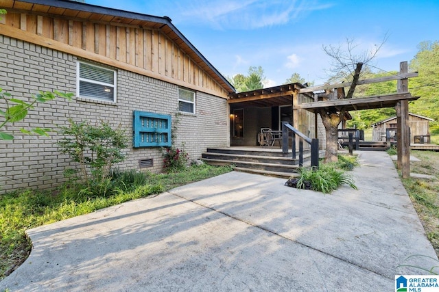 exterior space with board and batten siding and brick siding