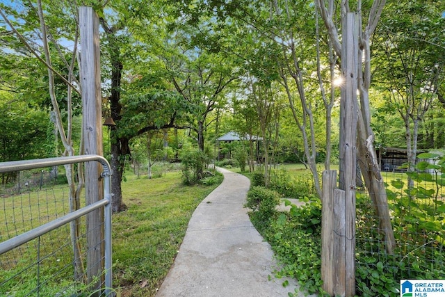 view of community with fence and a yard
