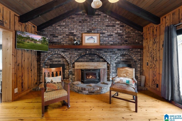 sitting room with wooden walls, wood ceiling, vaulted ceiling with beams, and hardwood / wood-style flooring