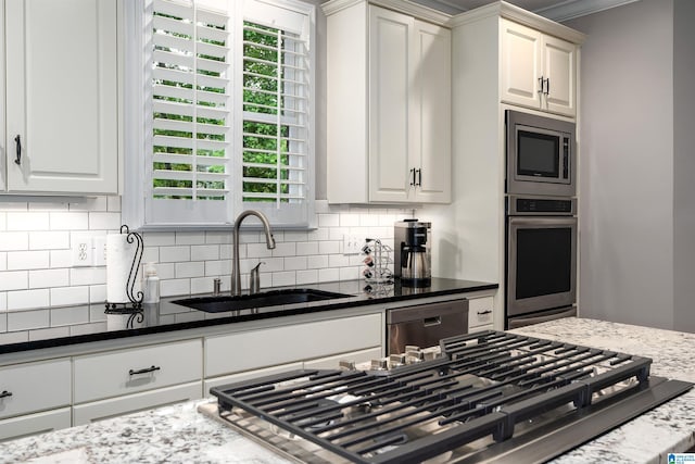 1012 Oak Tree Rd, Hoover, AL 35244 - kitchen featuring white cabinetry, a sink, dark stone countertops, appliances with stainless steel finishes, and backsplash