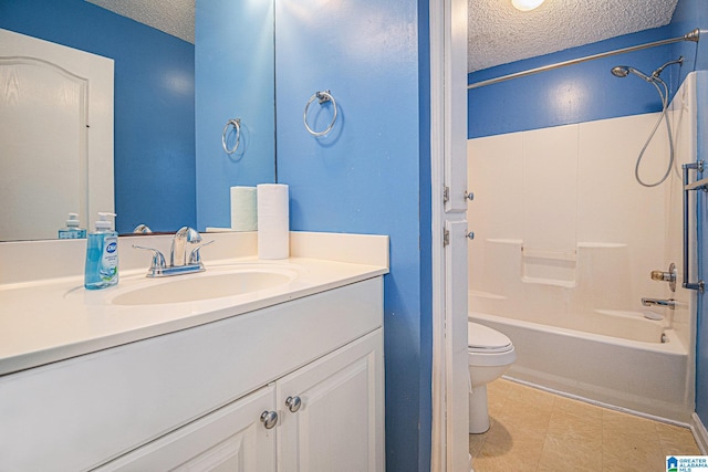 bathroom featuring vanity, bathing tub / shower combination, toilet, and a textured ceiling