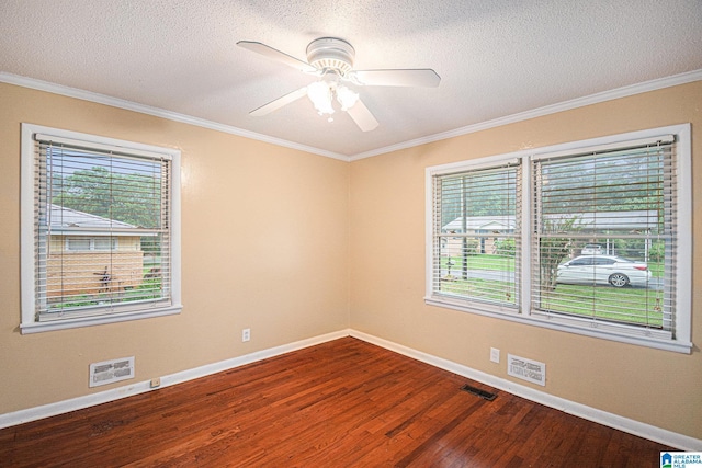 empty room with visible vents, ornamental molding, baseboards, ceiling fan, and dark wood-type flooring