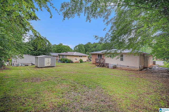 view of yard featuring central AC, a shed, and an outbuilding