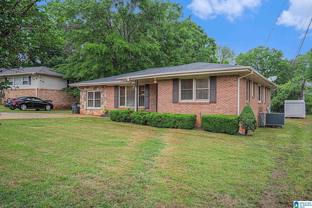 single story home with brick siding, a front yard, and cooling unit