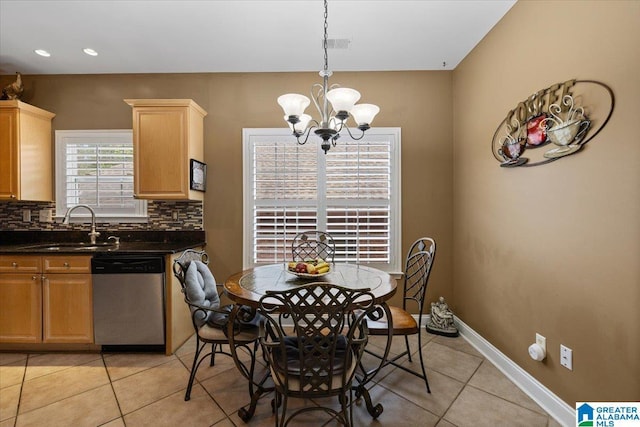 dining space featuring light tile patterned floors and a chandelier