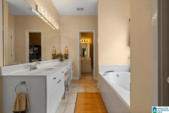 full bathroom featuring vanity, tile patterned floors, and a garden tub