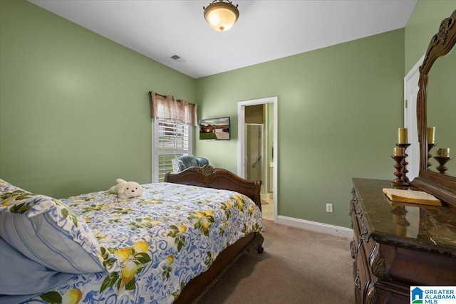bedroom featuring light carpet, baseboards, and connected bathroom