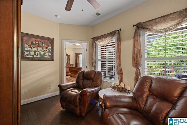living area with ceiling fan, wood finished floors, and baseboards