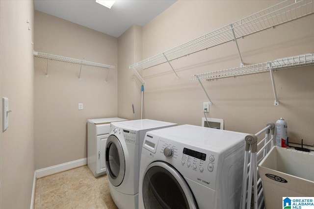 clothes washing area with washer and clothes dryer, baseboards, and light tile patterned floors
