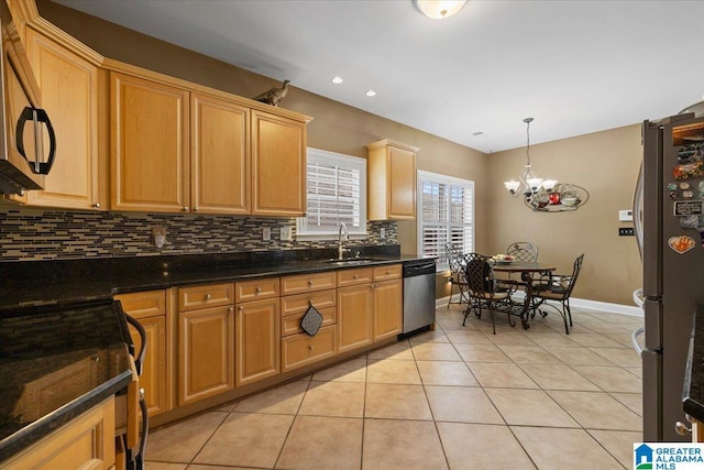 kitchen with stainless steel appliances, backsplash, light tile patterned flooring, a sink, and a chandelier