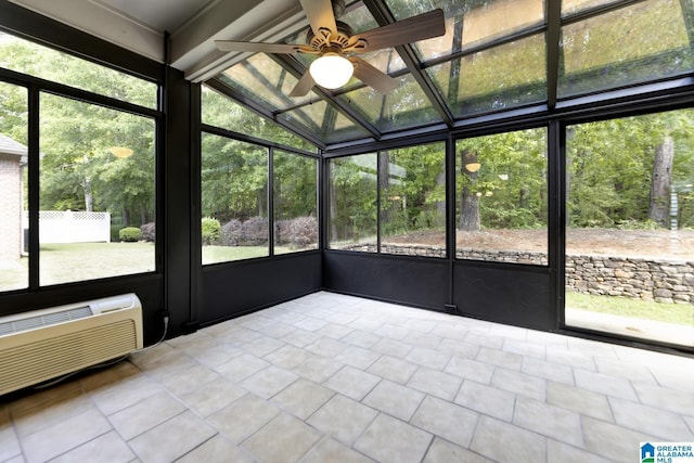 unfurnished sunroom with a ceiling fan and a wall mounted air conditioner