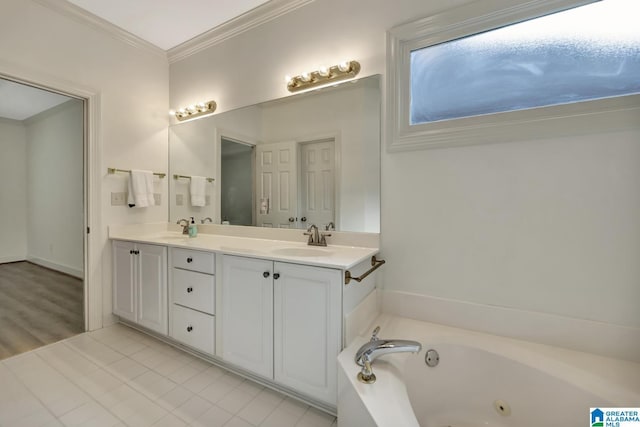 full bath with double vanity, ornamental molding, a tub with jets, and a sink