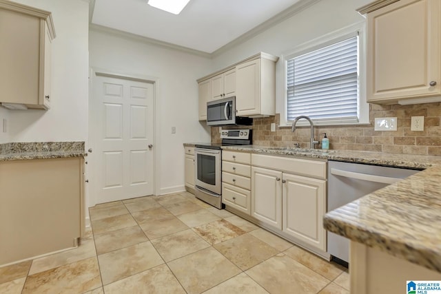 kitchen featuring backsplash, appliances with stainless steel finishes, ornamental molding, and a sink