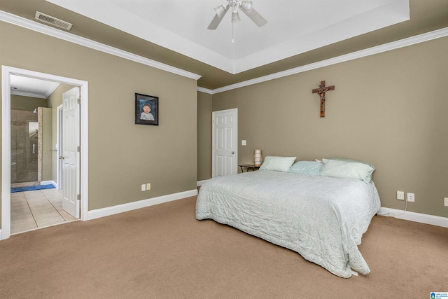 bedroom featuring visible vents, crown molding, carpet floors, baseboards, and a tray ceiling