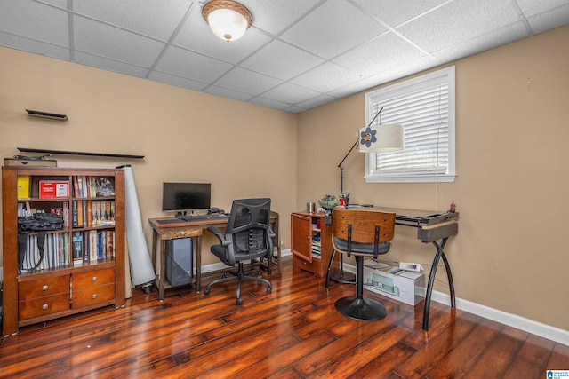 office area with baseboards, a paneled ceiling, and wood finished floors