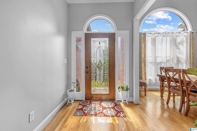 entryway featuring baseboards and wood finished floors