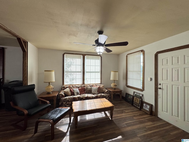 living room with ceiling fan, dark wood-style floors, and baseboards