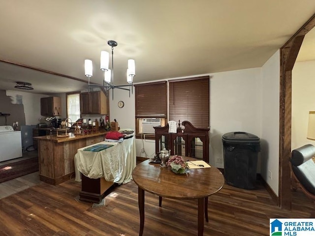 interior space with washer / clothes dryer, a chandelier, dark wood-style floors, and cooling unit