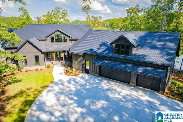 view of front of house with driveway and metal roof