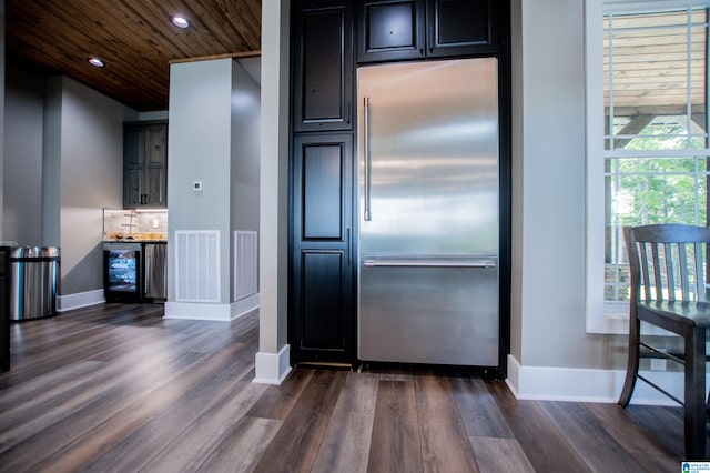 kitchen featuring baseboards, visible vents, stainless steel built in fridge, and dark wood-type flooring