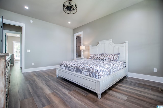 bedroom with dark wood-type flooring, recessed lighting, and baseboards