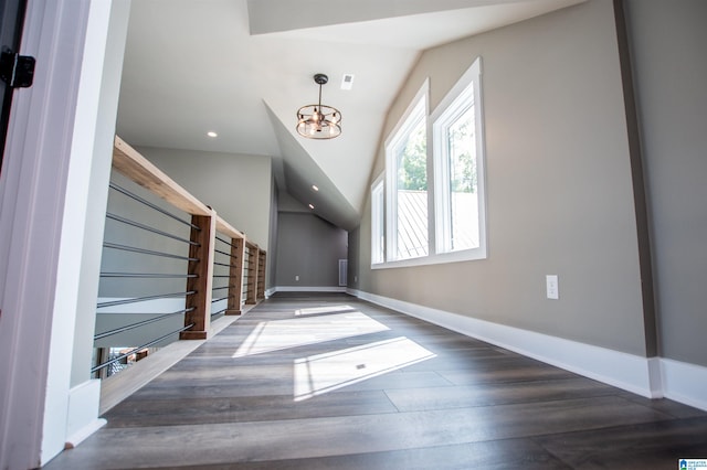 entrance foyer featuring a chandelier, wood finished floors, baseboards, lofted ceiling, and recessed lighting
