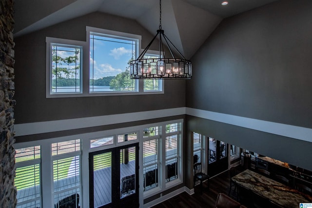 foyer entrance featuring an inviting chandelier, recessed lighting, vaulted ceiling, and dark wood finished floors