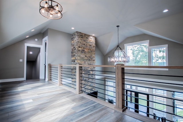 bonus room featuring lofted ceiling, recessed lighting, wood finished floors, and a notable chandelier