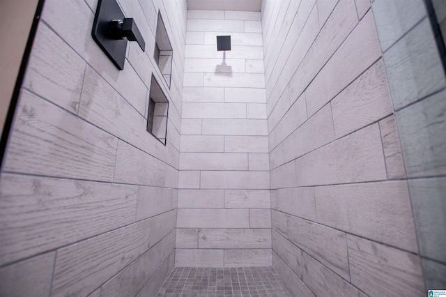 bathroom with a tile shower