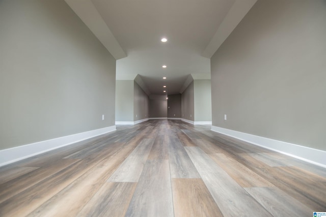 additional living space with recessed lighting, baseboards, and wood finished floors