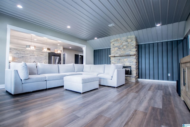living room with recessed lighting, wood finished floors, and a fireplace