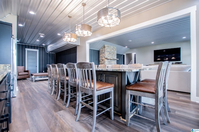 dining space featuring recessed lighting, wood finished floors, and a notable chandelier