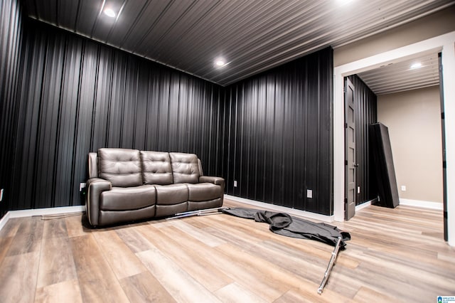 sitting room with baseboards, recessed lighting, and wood finished floors