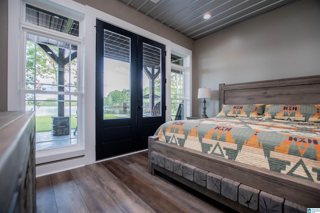 bedroom with french doors, dark wood-style floors, multiple windows, and access to exterior