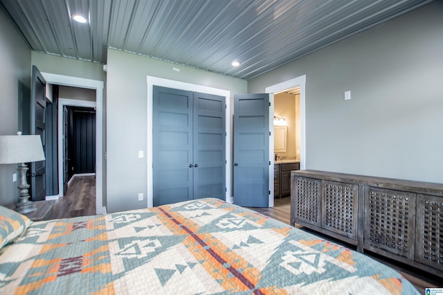 bedroom with a closet, recessed lighting, and wood finished floors