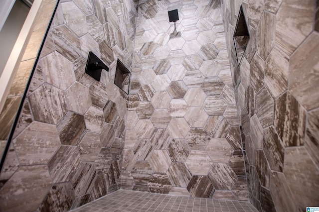 full bath with a tile shower