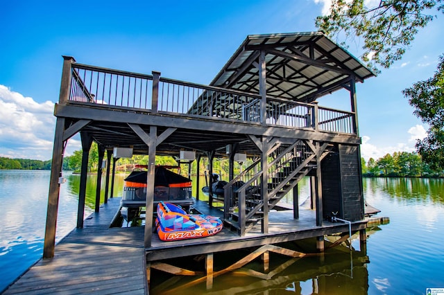 dock area featuring boat lift and a water view