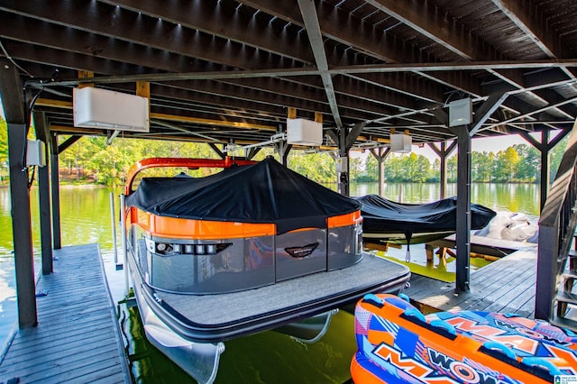 view of dock featuring boat lift and a water view