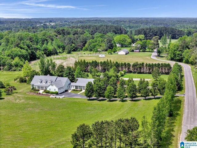 birds eye view of property featuring a forest view