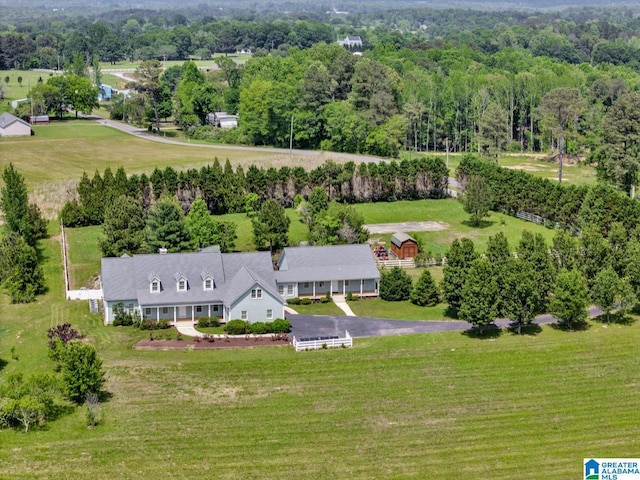 birds eye view of property with a forest view